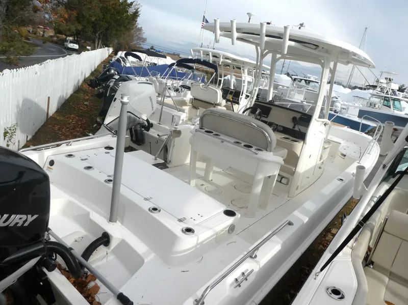 Slide: The Image of 2019 Boston Whaler 270 Dauntless boat with Mercury engine, docked outdoors. - 3