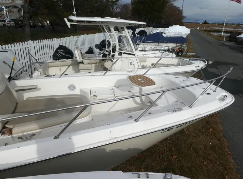 Slide: The Image of 2019 Boston Whaler 270 Dauntless boat docked near a white fence. - 5