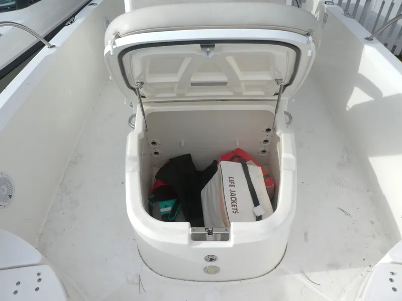 Slide: The Image of Open storage compartment on 2019 Boston Whaler 270 Dauntless with life jackets inside. - 9