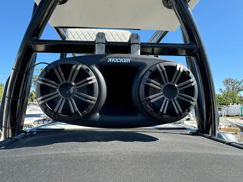 Slide: The Image of Kicker speakers on 2017 Action Craft 24 A.C.E. boat, clear blue sky background. - 12