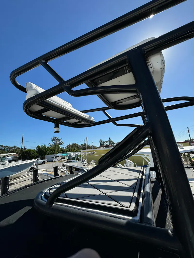 Slide: The Image of 2017 Action Craft 24 A.C.E. boat with elevated seating under clear blue sky. - 16