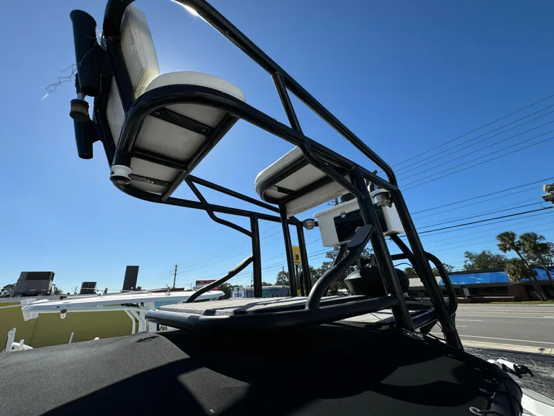 Slide: The Image of 2017 Action Craft 24 A.C.E. boat seating and structure under clear blue sky. - 18