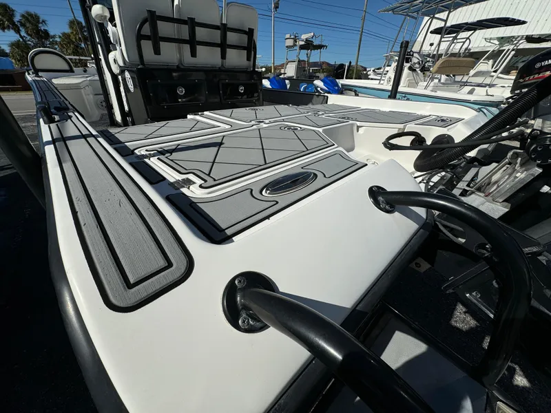 Slide: The Image of 2017 Action Craft 24 A.C.E. boat deck with seating and storage compartments. - 22