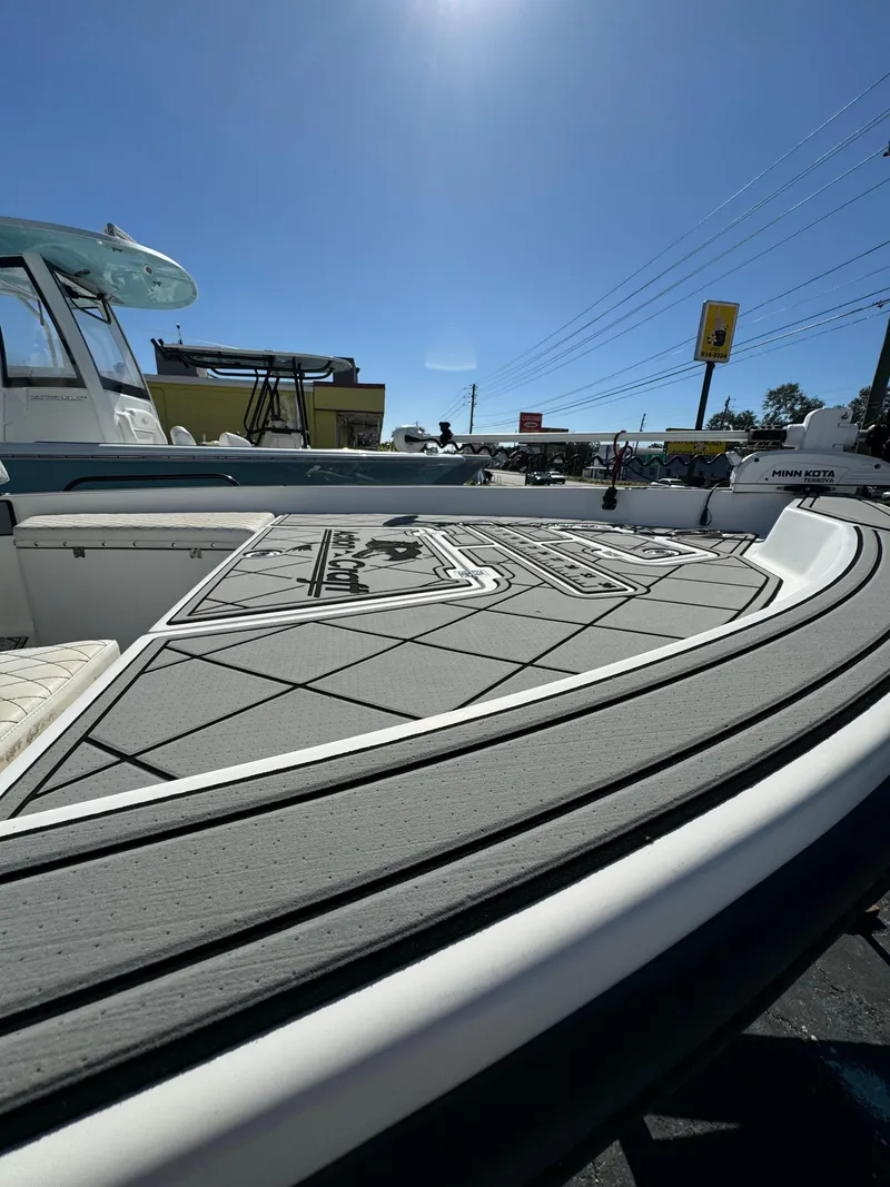 Slide: The Image of 2017 Action Craft 24 A.C.E. boat deck under clear blue sky. - 30