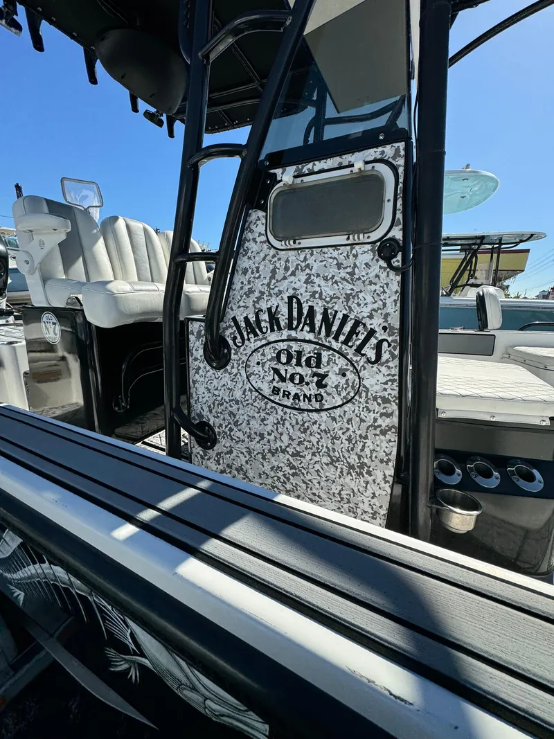 Slide: The Image of 2017 Action Craft 24 A.C.E. boat with Jack Daniels branding, docked under clear blue sky. - 33