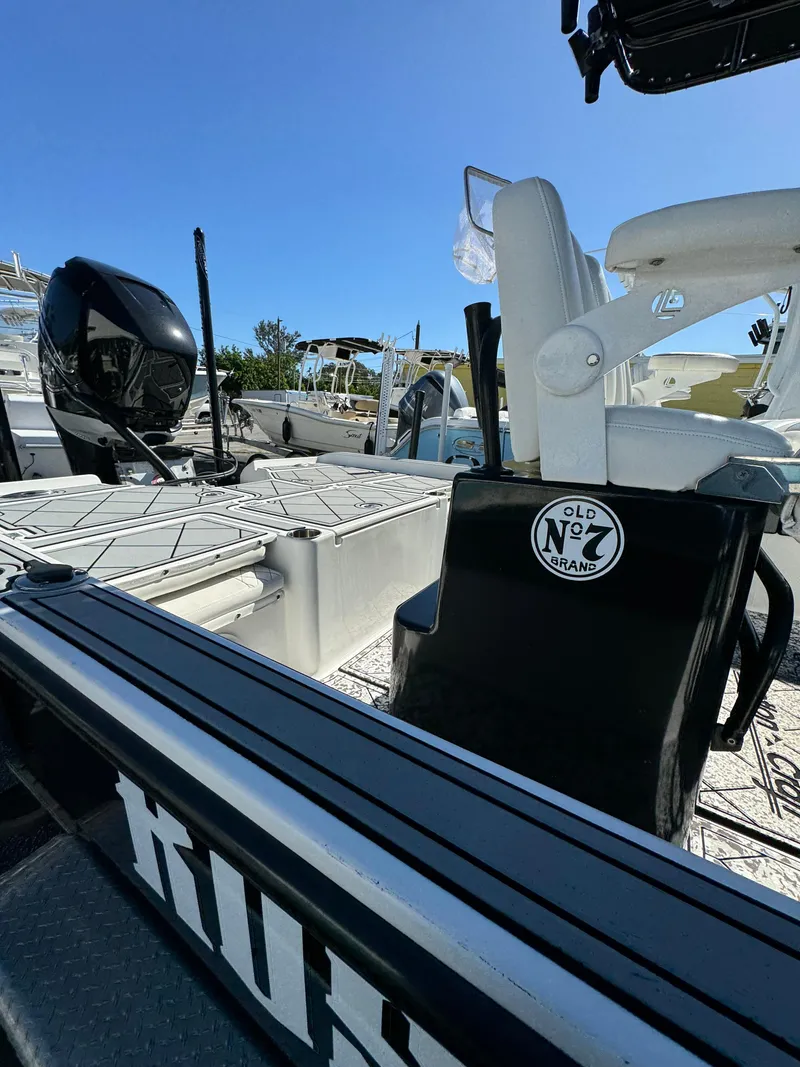 Slide: The Image of 2017 Action Craft 24 A.C.E. boat with seating and motor, under clear blue sky. - 35