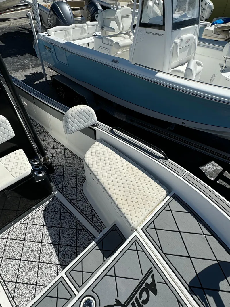 Slide: The Image of 2017 Action Craft 24 A.C.E. boat with sleek interior and diamond-patterned seating. - 8