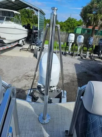 Slide: The Image of 2022 Nepallo 20QL boat with outboard motor in a marina setting. - 6