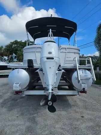 Slide: The Image of 2022 Nepallo 20QL pontoon boat with outboard motor, parked on gravel. - 7