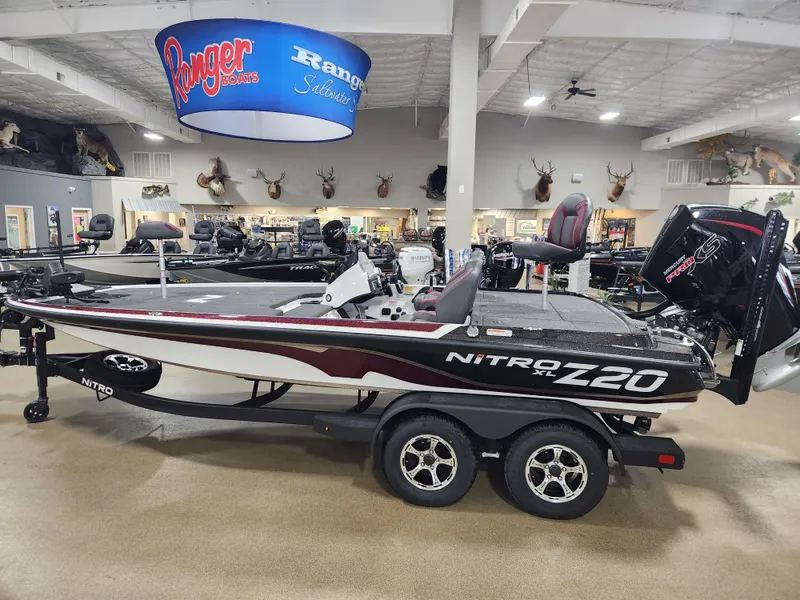 The Image of 2025 Nitro Z20 XL Pro boat displayed in showroom with mounted motor. - 0