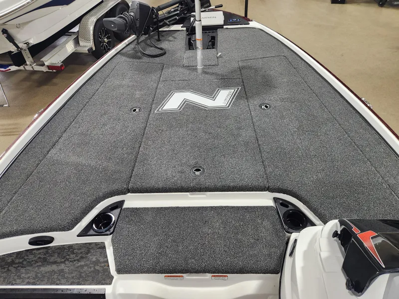 Slide: The Image of 2025 Nitro Z20 XL Pro boat deck with gray carpeting and logo. - 11