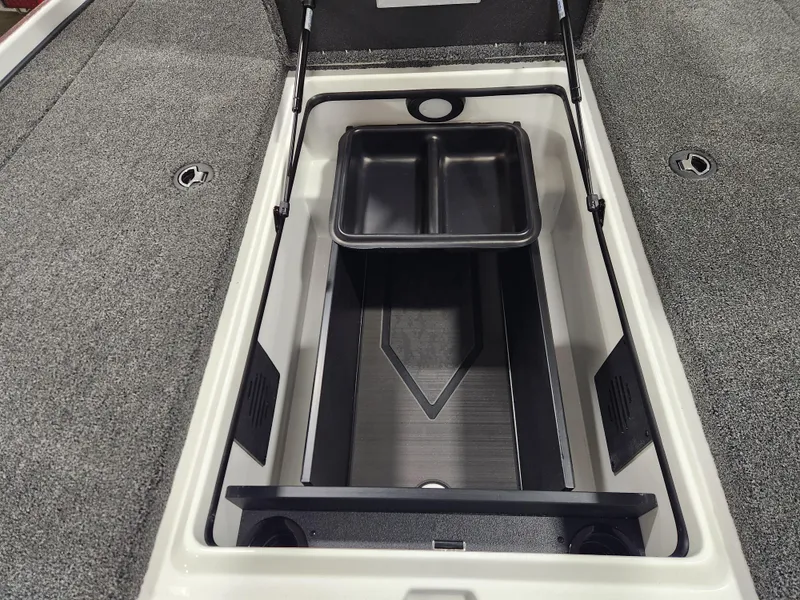 Slide: The Image of 2025 Nitro Z20 XL Pro boat storage compartment with dual trays and carpeted interior. - 12