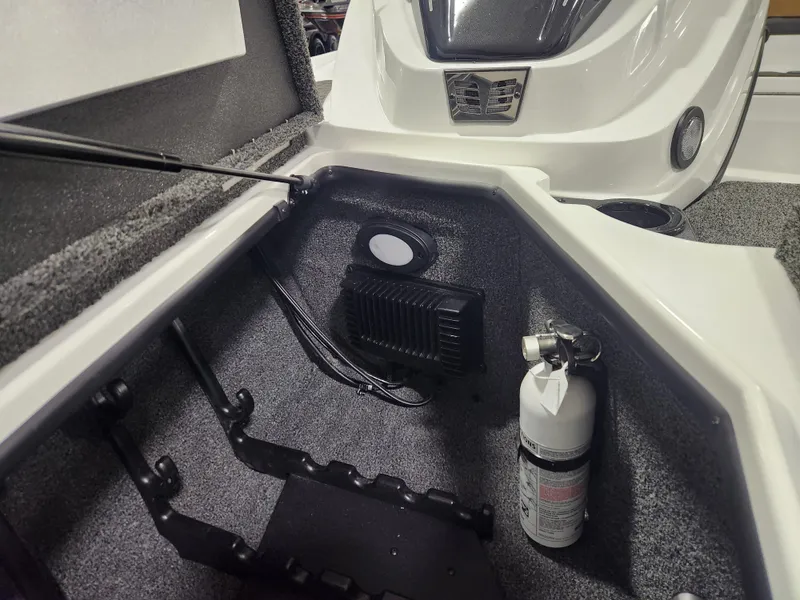 Slide: The Image of 2025 Nitro Z20 XL Pro boat storage compartment with fire extinguisher and equipment. - 16
