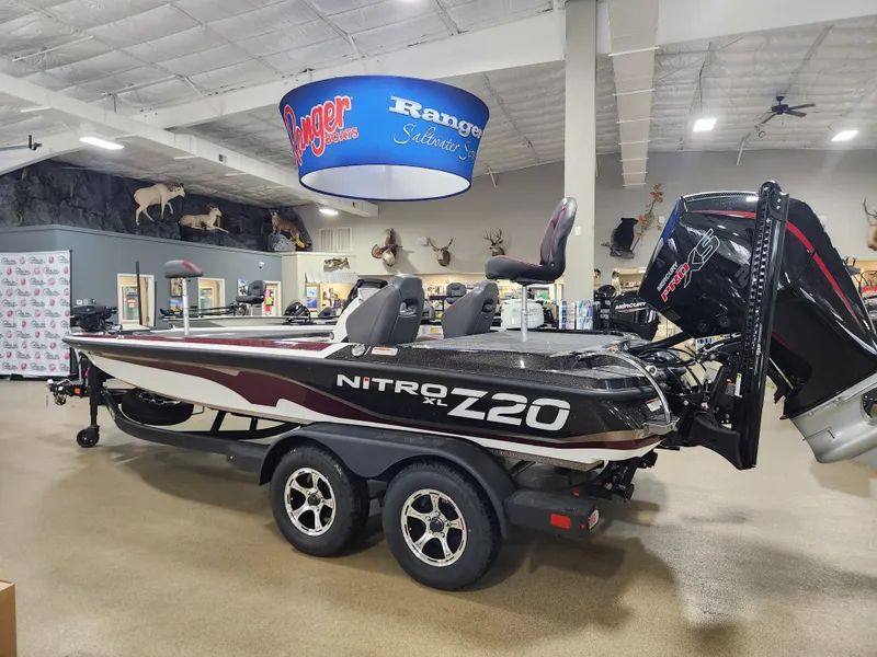 Slide: The Image of 2025 Nitro Z20 XL Pro boat displayed in showroom with mounted engine. - 2