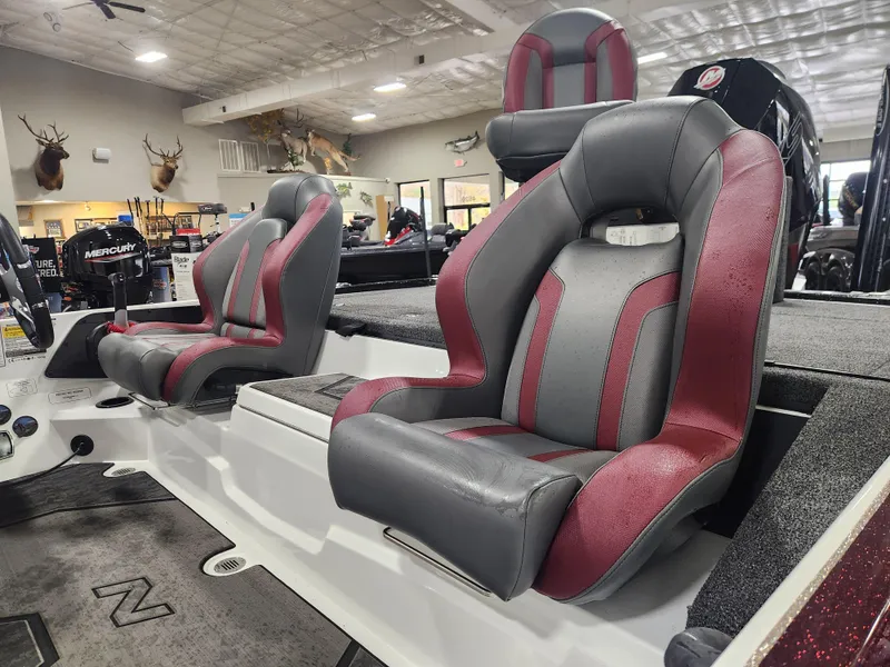 Slide: The Image of 2025 Nitro Z20 XL Pro boat interior with red and gray seats in showroom. - 21