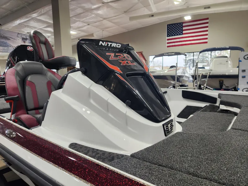 Slide: The Image of 2025 Nitro Z20 XL Pro boat in showroom with American flag backdrop. - 23