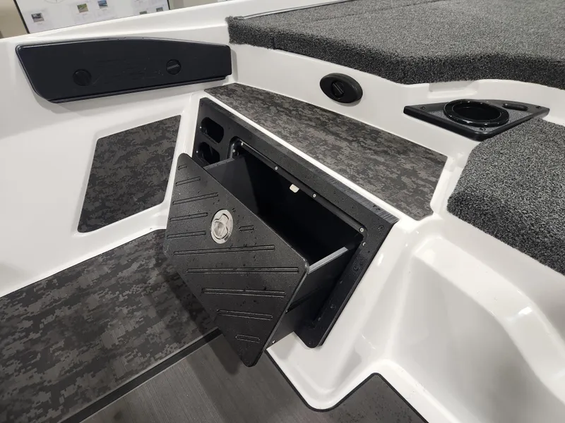 Slide: The Image of 2025 Nitro Z20 XL Pro boat storage compartment with sleek design and cup holder. - 30