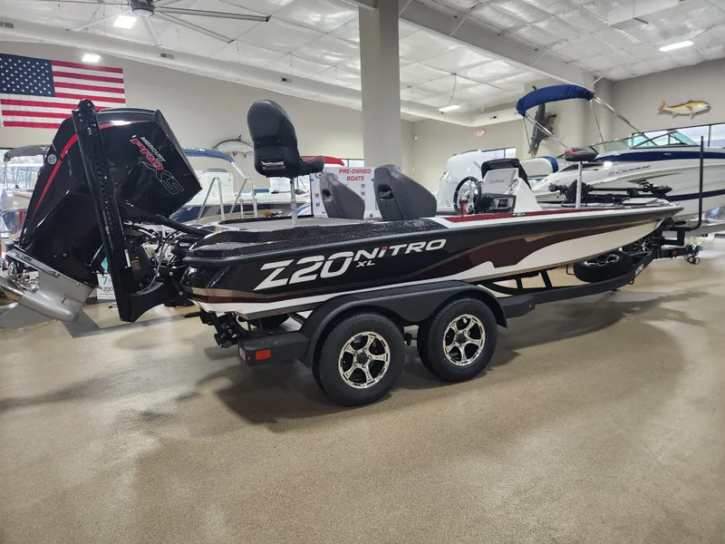 Slide: The Image of 2025 Nitro Z20 XL Pro boat in showroom, featuring sleek design and dual axle trailer. - 6