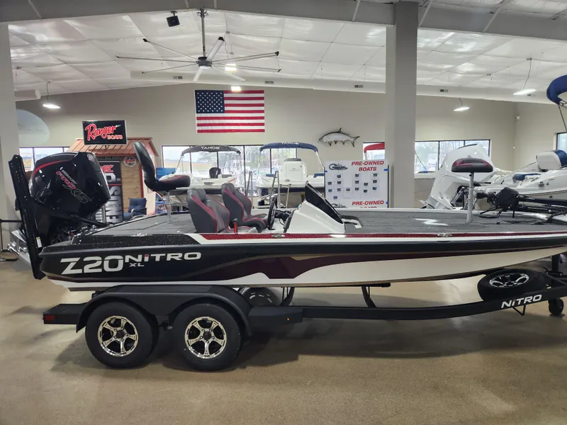 Slide: The Image of 2025 Nitro Z20 XL Pro boat in showroom with American flag backdrop. - 7