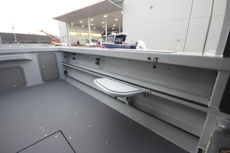 Slide: The Image of 2025 Weldcraft 240 Ocean King boat interior with storage and seating features. - 14