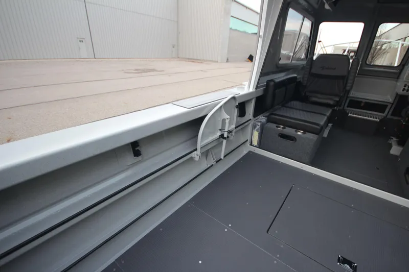 Slide: The Image of Interior of 2025 Weldcraft 240 Ocean King boat, showcasing seating and spacious layout. - 15