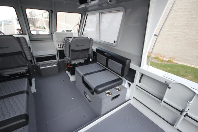 Slide: The Image of Interior of 2025 Weldcraft 240 Ocean King boat, featuring modern seating and spacious layout. - 16