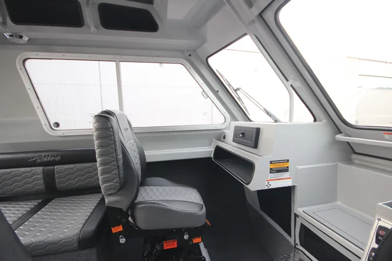 Slide: The Image of Interior of 2025 Weldcraft 240 Ocean King boat, featuring modern seating and dashboard. - 17