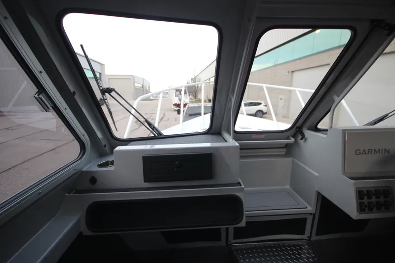Slide: The Image of Interior view of 2025 Weldcraft 240 Ocean King F300XCB boat, featuring navigation equipment. - 19