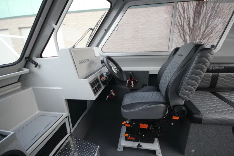 Slide: The Image of Interior of 2025 Weldcraft 240 Ocean King boat, featuring modern steering and seating. - 21