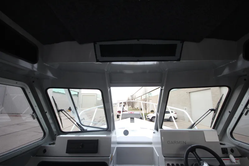 Slide: The Image of Interior view of 2025 Weldcraft 240 Ocean King boat cockpit with Garmin navigation system. - 25