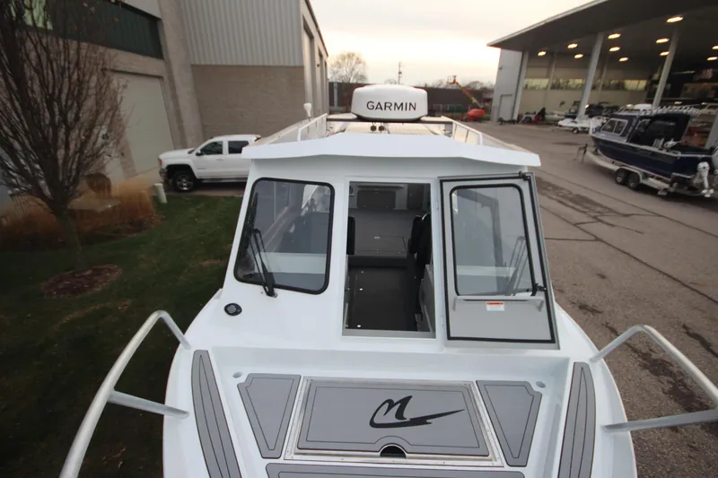 Slide: The Image of 2025 Weldcraft 240 Ocean King boat with Garmin equipment, docked near a showroom. - 29