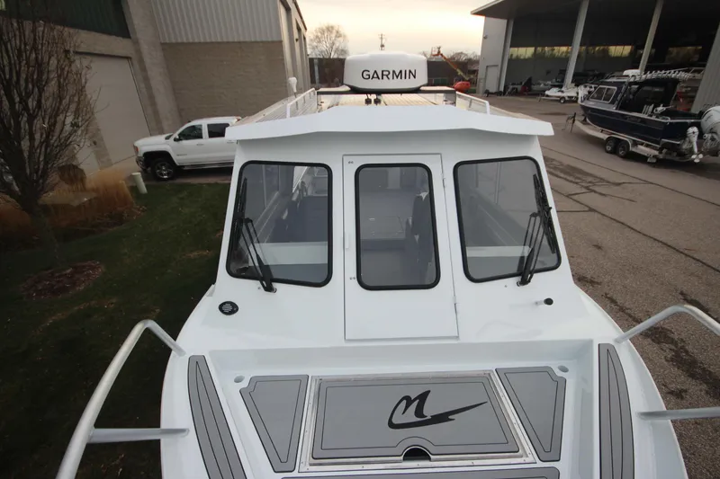 Slide: The Image of 2025 Weldcraft 240 Ocean King boat with Garmin equipment, parked outdoors. - 30
