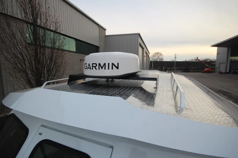 Slide: The Image of 2025 Weldcraft 240 Ocean King with Garmin radar on roof, parked near industrial buildings. - 31