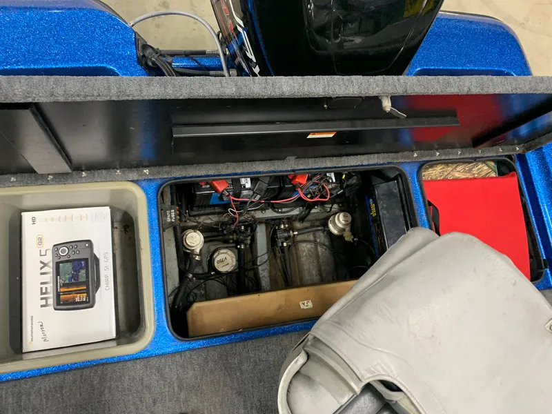 Slide: The Image of 1998 ProCraft 200 Bass boat interior with engine compartment and electronics. - 10