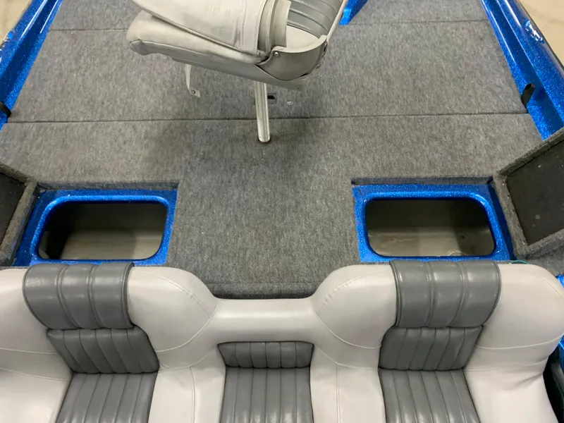 Slide: The Image of 1998 ProCraft 200 Bass boat interior with gray seating and storage compartments. - 11