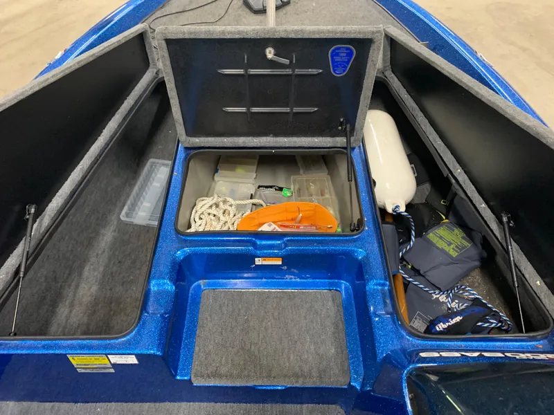 Slide: The Image of Open storage compartments in a 1998 ProCraft 200 Bass boat, showing gear and equipment. - 12