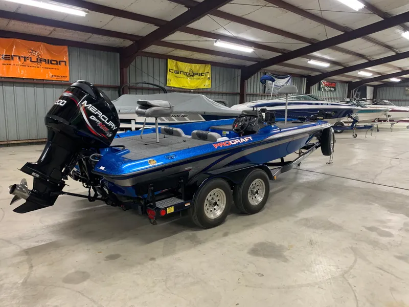 Slide: The Image of 1998 ProCraft 200 Bass boat with Mercury outboard in a storage facility. - 2