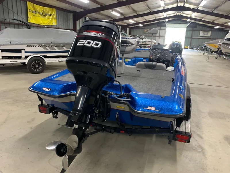 Slide: The Image of 1998 ProCraft 200 Bass boat with Mercury 200 engine in storage facility. - 3