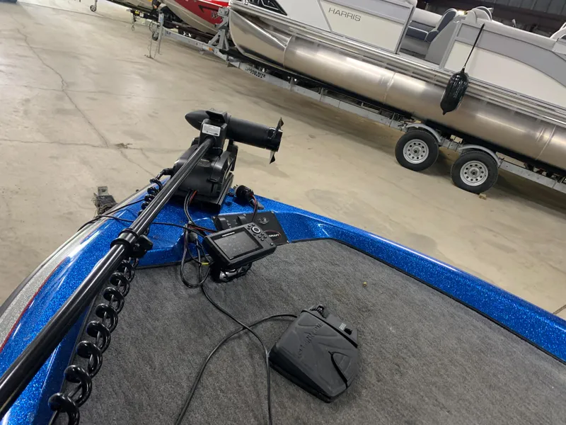 Slide: The Image of 1998 ProCraft 200 Bass boat with trolling motor and fish finder in a showroom. - 7