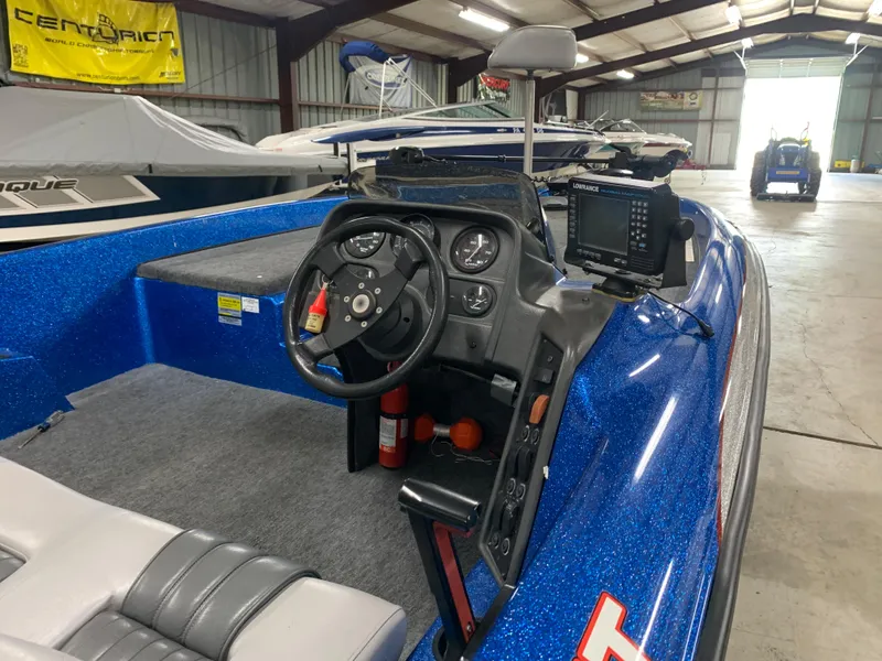 Slide: The Image of 1998 ProCraft 200 Bass boat interior with steering wheel and navigation equipment. - 9