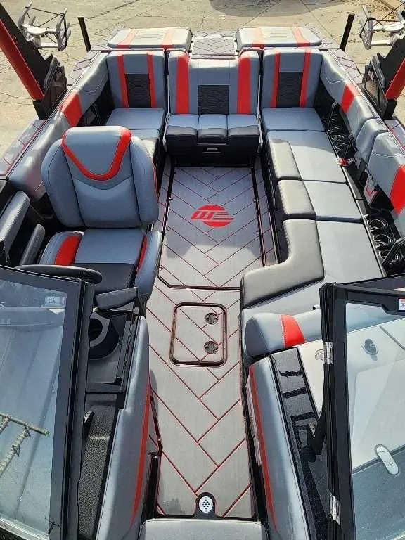Slide: The Image of 2025 Malibu Wakesetter 23 LSV interior with gray and red seating, spacious layout, and modern design. - 12