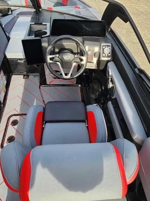 Slide: The Image of 2025 Malibu Wakesetter 23 LSV interior with modern dashboard and red-accented seating. - 15