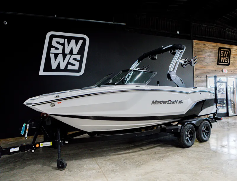 The Image of 2024 MasterCraft NXT20 boat on display in showroom with SWWS branding. - 0