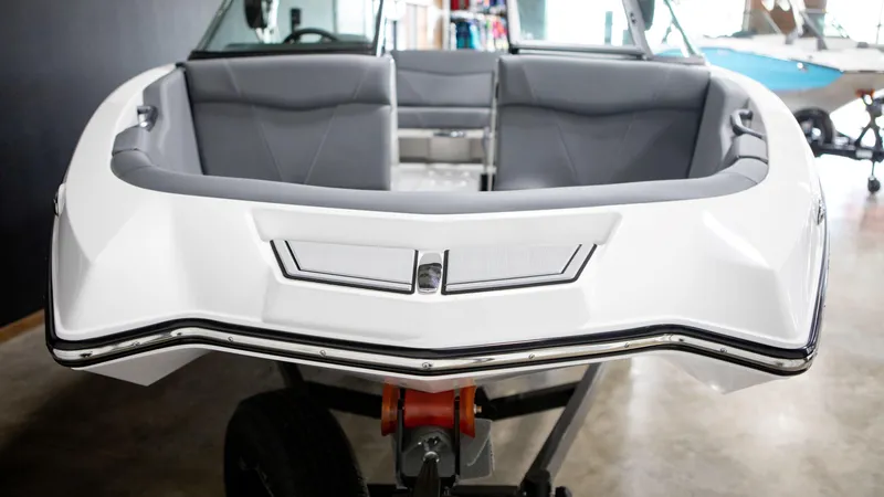 Slide: The Image of 2024 MasterCraft NXT20 boat interior with gray seating and sleek design. - 2