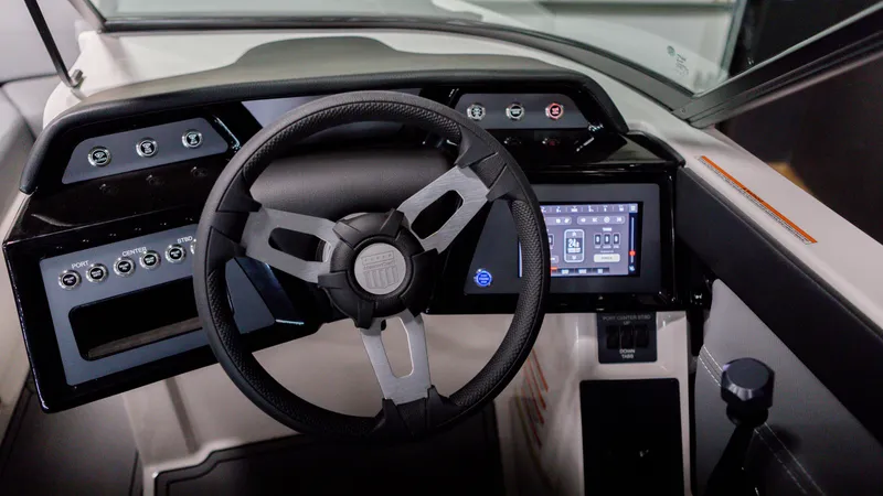 Slide: The Image of 2024 MasterCraft NXT20 boat dashboard with steering wheel and digital display. - 4