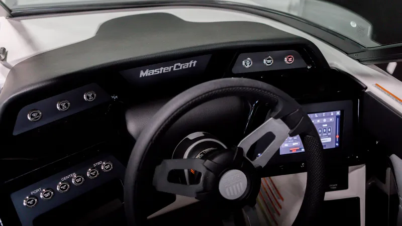 Slide: The Image of 2024 MasterCraft NXT20 boat dashboard with steering wheel and digital display. - 5