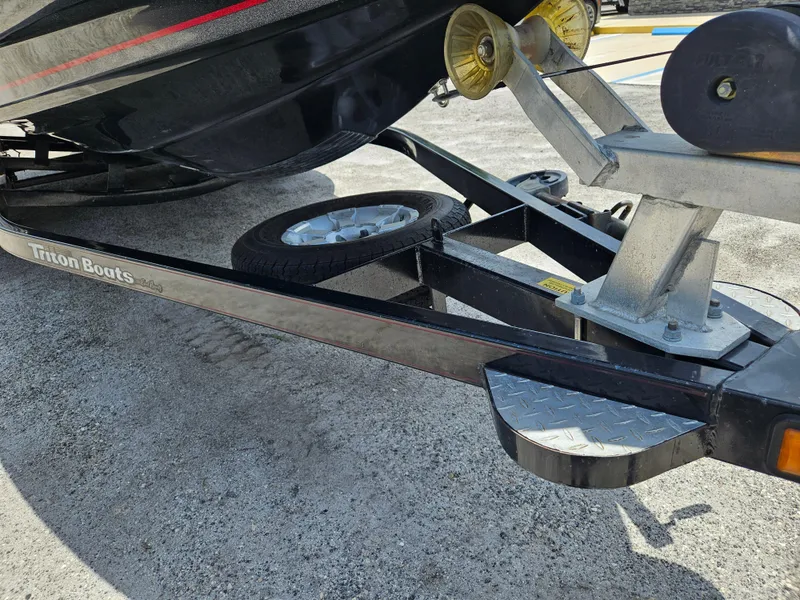 Slide: The Image of 2006 Triton Tr-21X HP boat storage compartment with open lid and visible interior. - 23