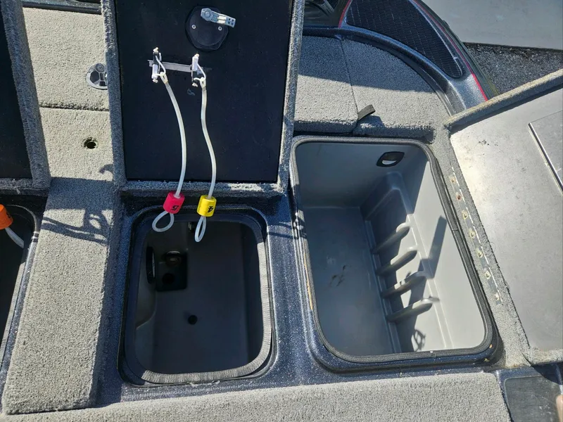 Slide: The Image of Open storage compartment in a 2006 Triton Tr-21X HP boat. - 25