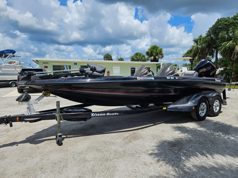 Slide: The Image of 2006 Triton Tr-21X HP boat on trailer, parked outdoors. - 3