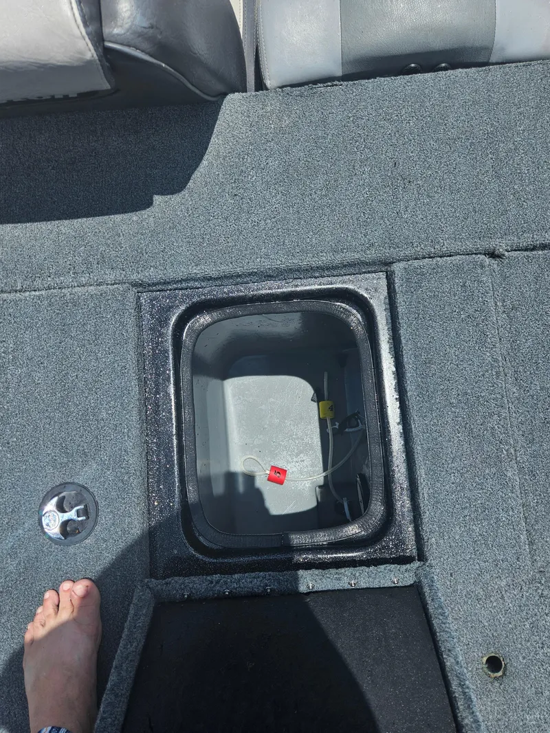Slide: The Image of Open storage compartment on 2006 Triton Tr-21X HP boat. - 32